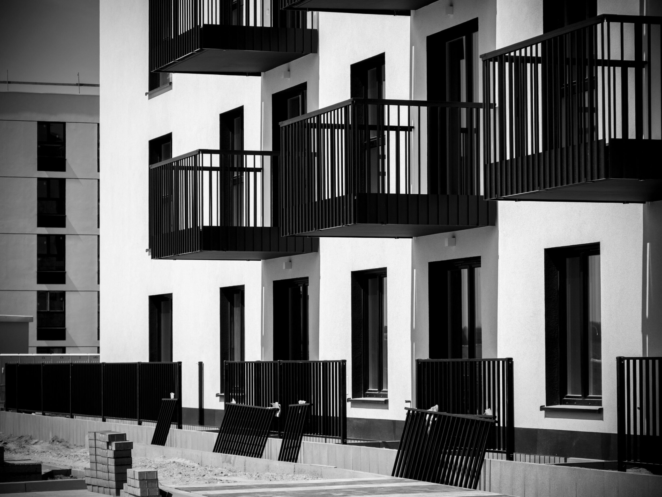 service-1 Black and white photo of contemporary apartment balconies in Wrocław, Poland.